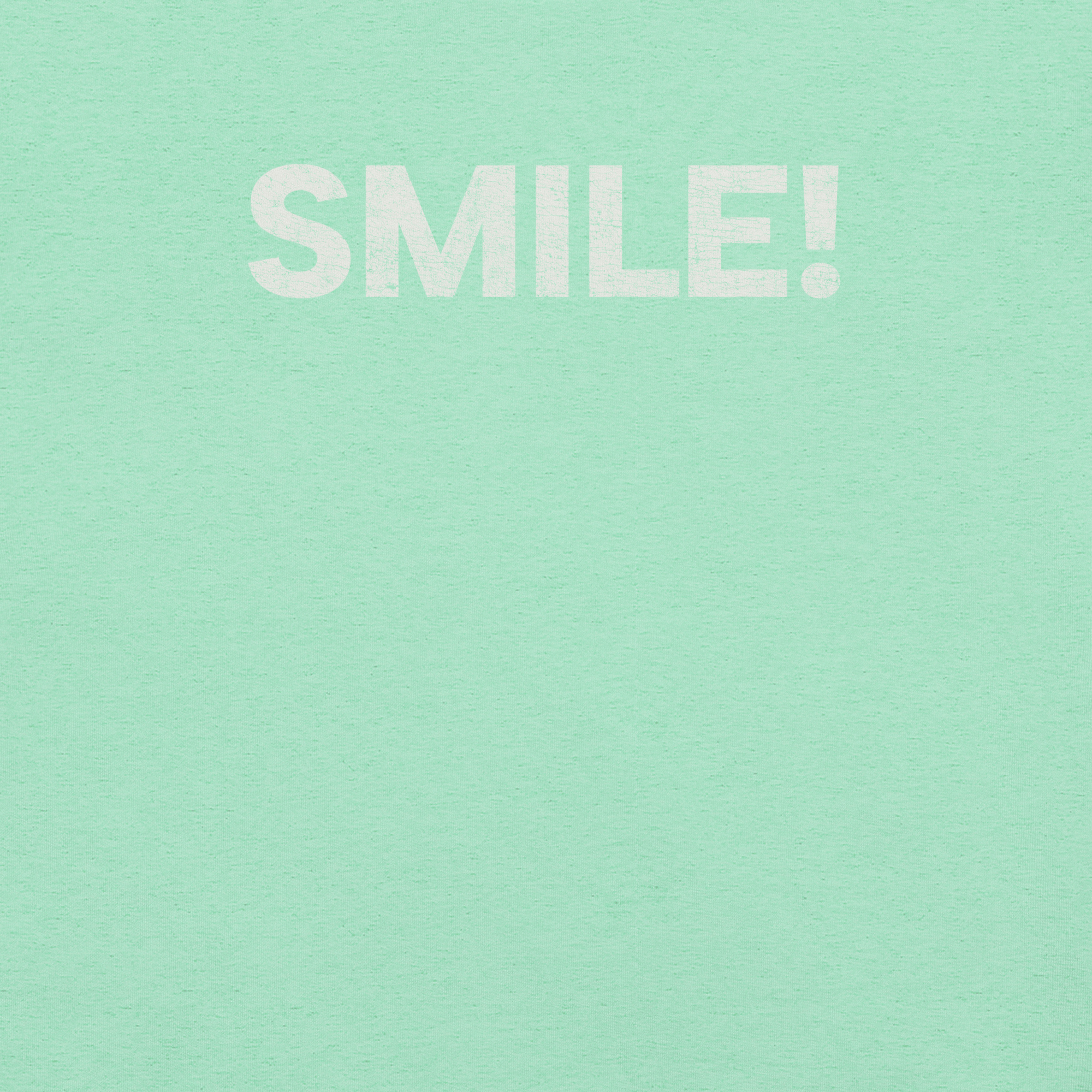 Close-up of heather mint Milk Sandwich t-shirt with the word "SMILE!" printed in bold, distressed white text across the chest.