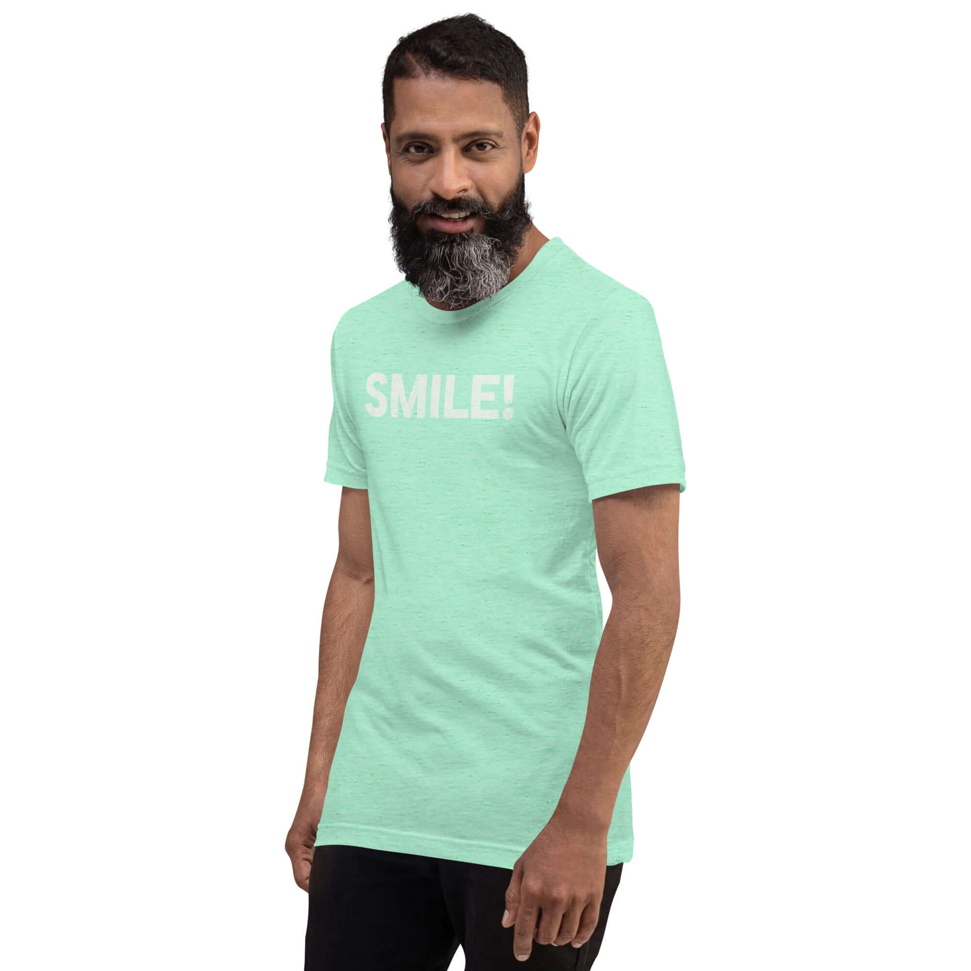 Man in a heather mint Milk Sandwich t-shirt featuring the word "SMILE!" in bold, distressed white letters, posing confidently with a slight turn against a white background.