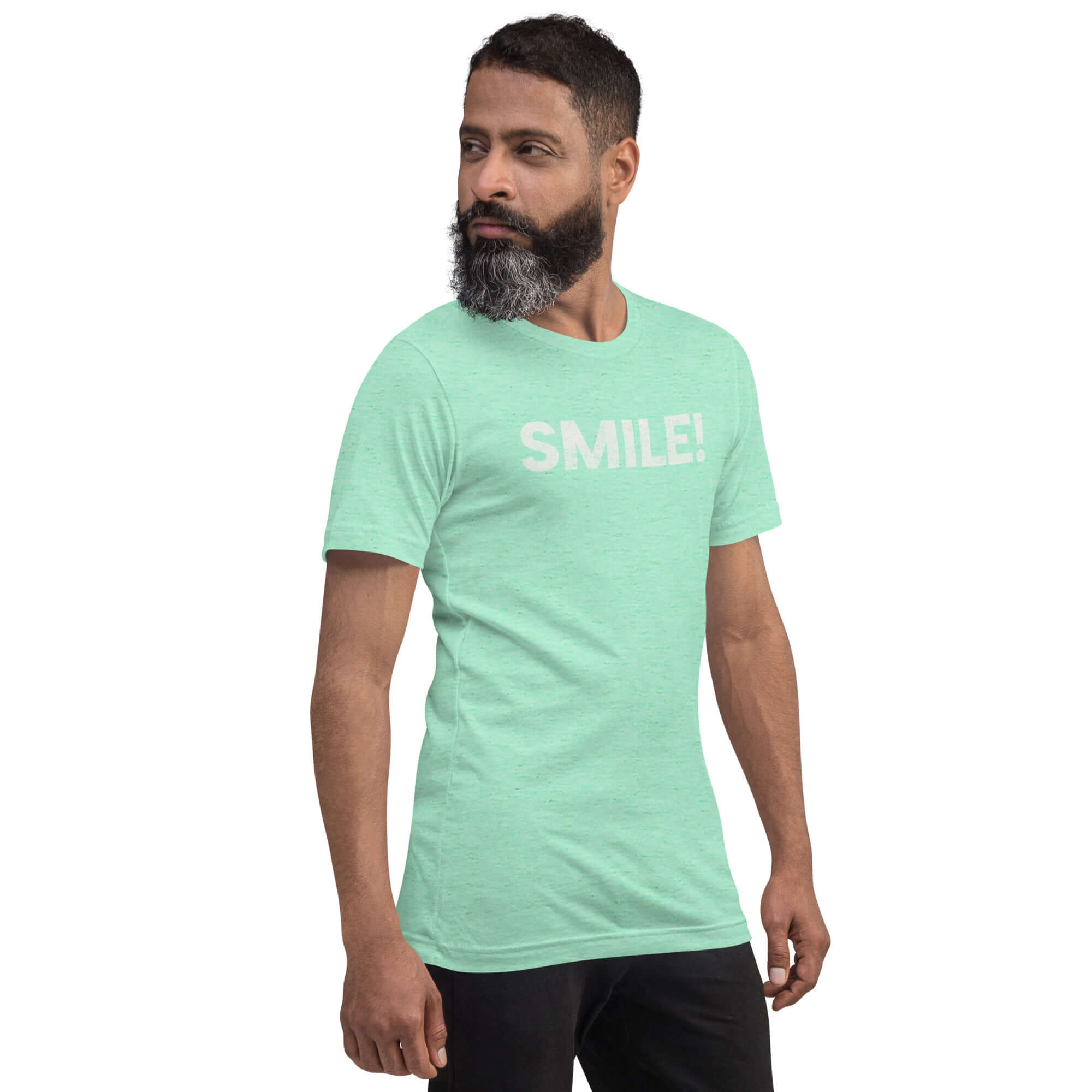 Side-facing man wearing heather mint Milk Sandwich t-shirt with distressed white text that reads SMILE! on the chest, set against a white backdrop.