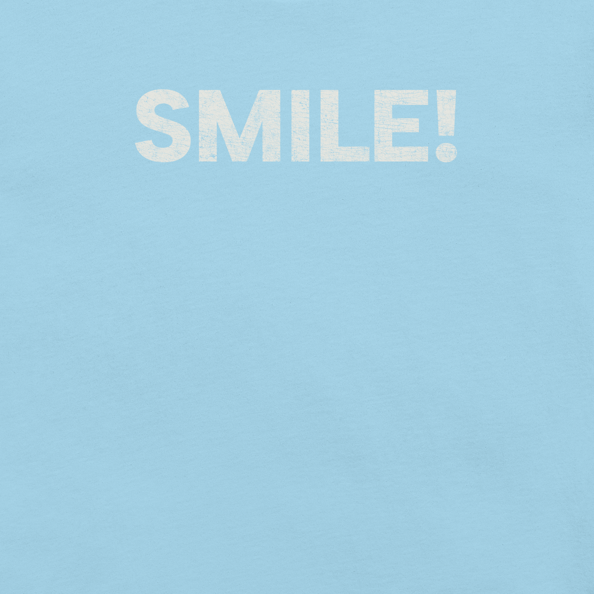 Close-up of ocean blue Milk Sandwich t-shirt with the word "SMILE!" printed in bold, distressed white text across the chest.