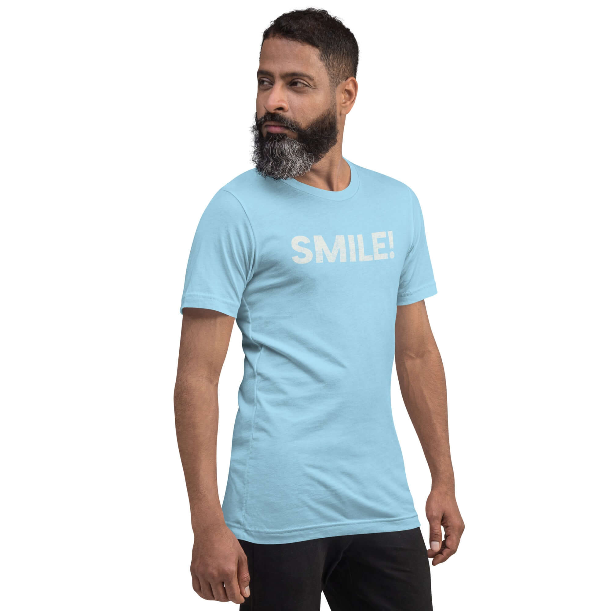 Side-facing man wearing ocean blue Milk Sandwich t-shirt with distressed white text that reads SMILE! on the chest, set against a white backdrop.