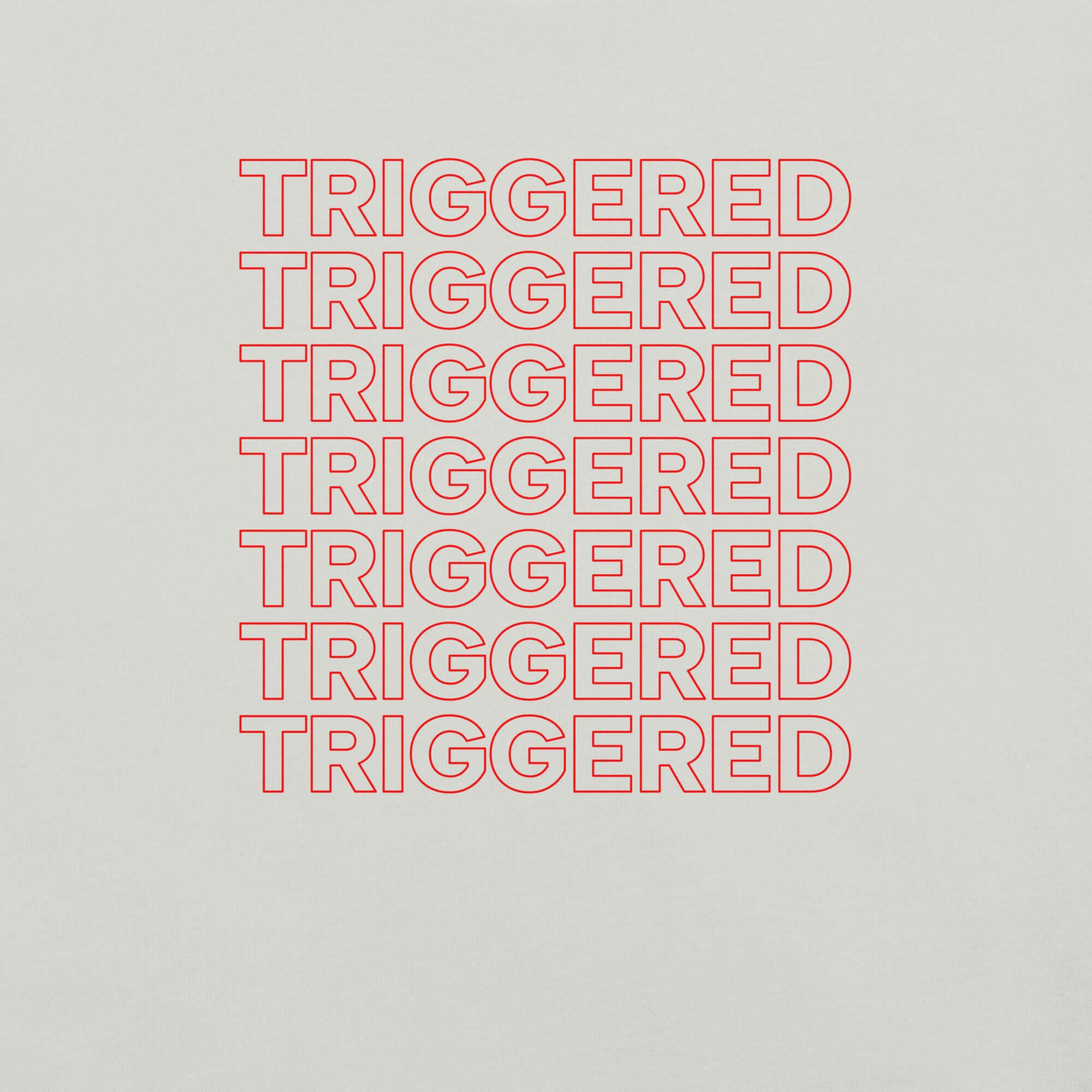 Close-up of silver t-shirt fabric with bold red “TRIGGERED” text repeated in stacked rows.          
