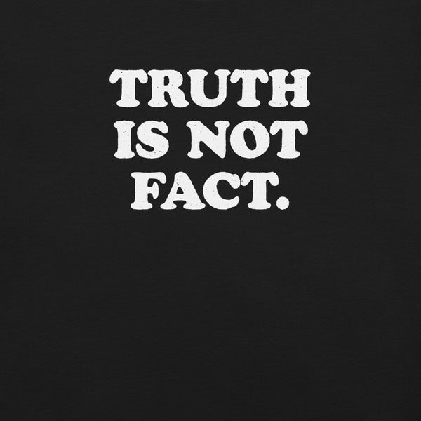Close-up of black Milk Sandwich T-shirt with bold white text that reads Truth Is Not Fact, minimalist graphic tee with a bold statement.