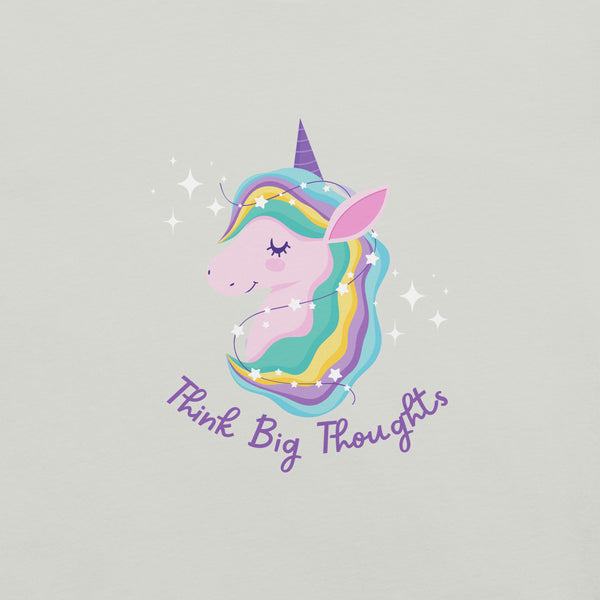 Close-up of a silver Milk Sandwich t-shirt with a pastel unicorn illustration and the phrase Think Big Thoughts in purple script, surrounded by sparkles.