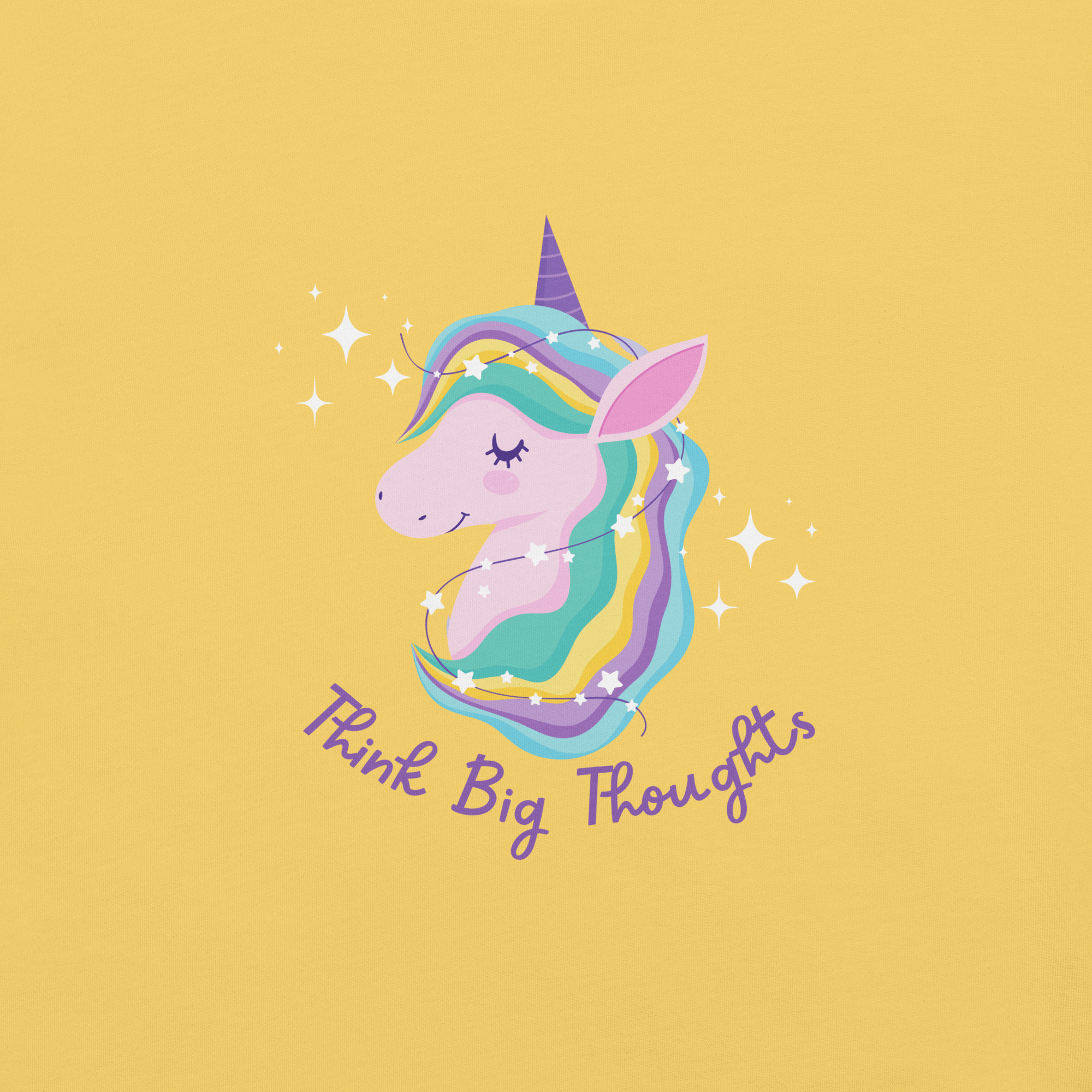 Close-up of a yelow Milk Sandwich t-shirt with a pastel unicorn illustration and the phrase Think Big Thoughts in purple script, surrounded by sparkles.