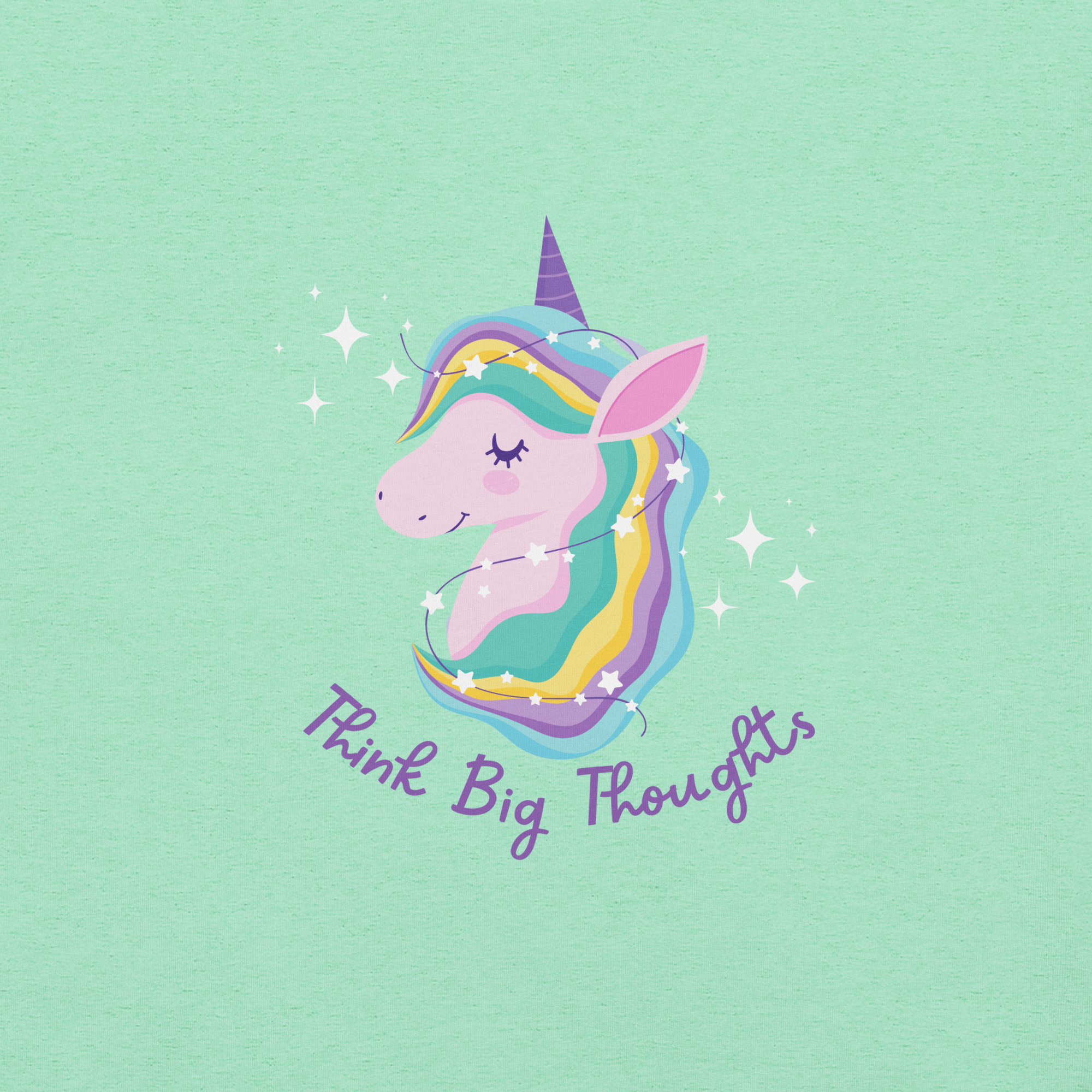 Close-up of a mint Milk Sandwich t-shirt with a pastel unicorn illustration and the phrase Think Big Thoughts in purple script, surrounded by sparkles.