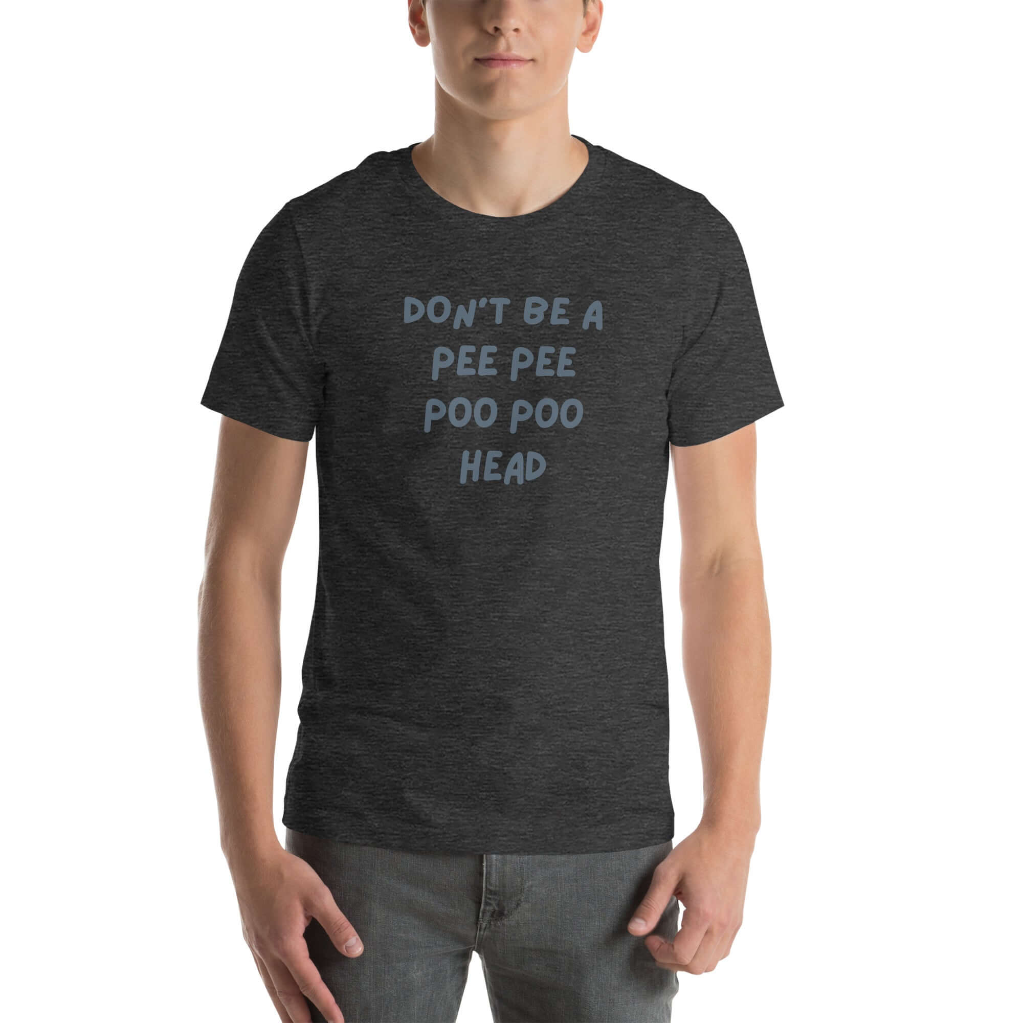 Man wearing dark grey “DON’T BE A PEE PEE POO POO HEAD” t-shirt, standing casually with hands by pockets.