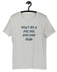 Light gret t-shirt on hanger with bold blue text: “DON’T BE A PEE PEE POO POO HEAD”.