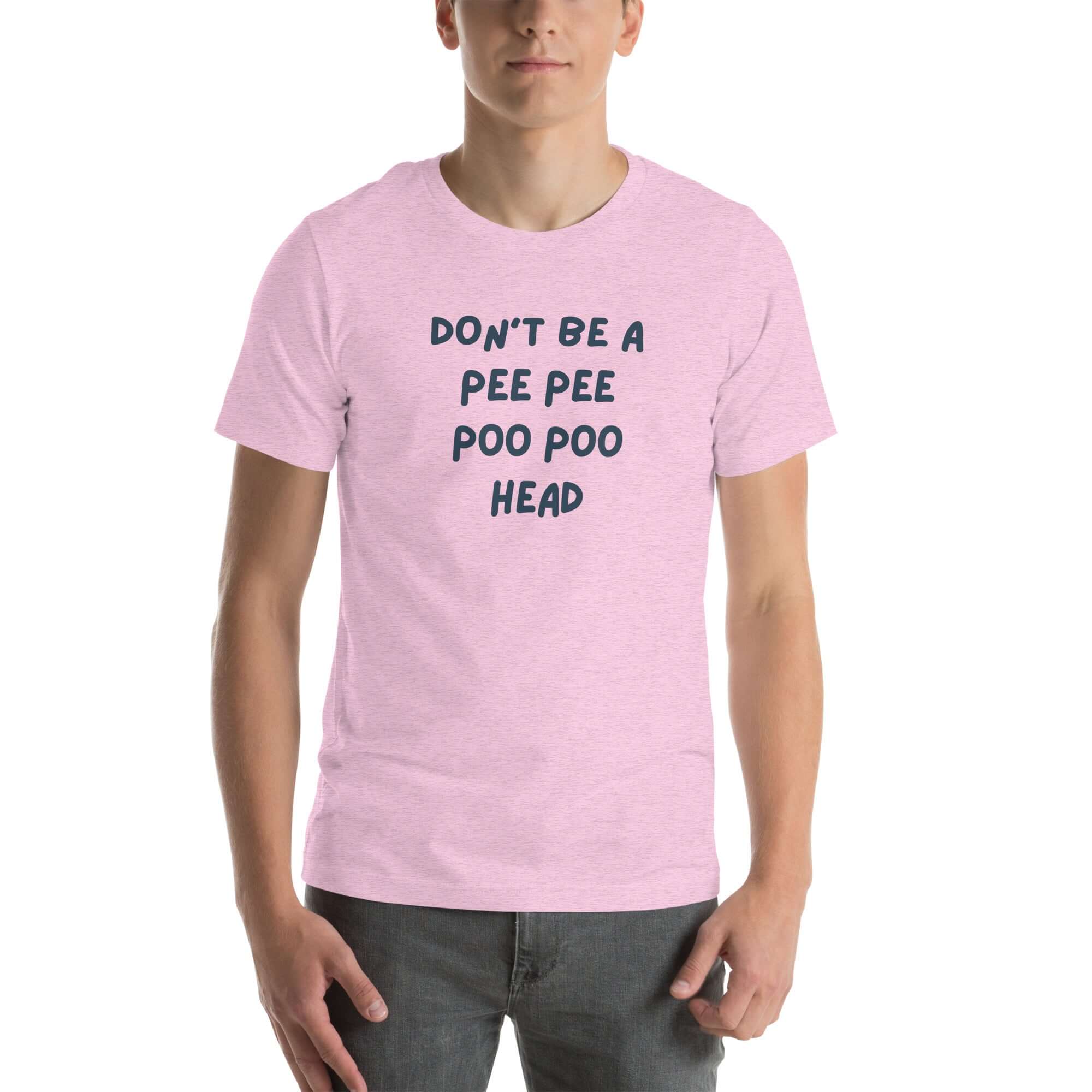 Man wearing lilac “DON’T BE A PEE PEE POO POO HEAD” t-shirt, standing casually with hands by pockets.