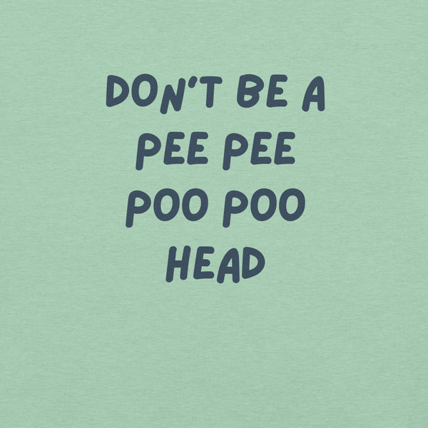 Man wearing mint “DON’T BE A PEE PEE POO POO HEAD” t-shirt, standing casually with hands by pockets.