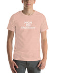 Man wearing a peach t-shirt with the text ‘HIGH ON CREATIVITY’ in bold white capital letters, centered on the chest