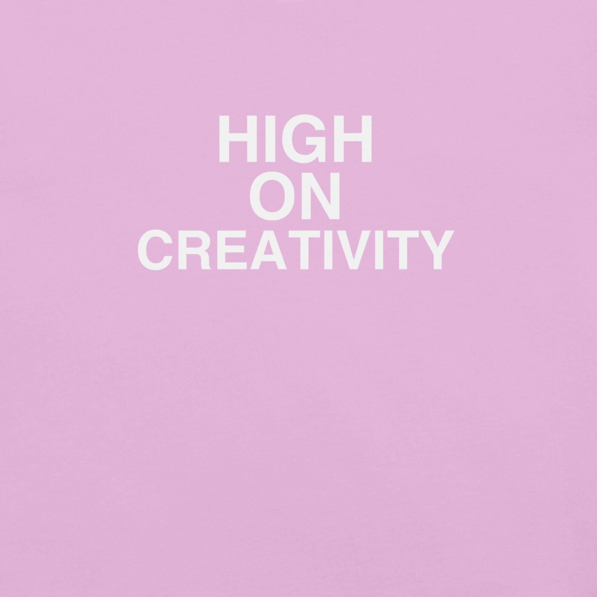 Close-up of Lilac t-shirt fabric with the phrase “HIGH ON CREATIVITY” printed in bold white uppercase letters in three lines.