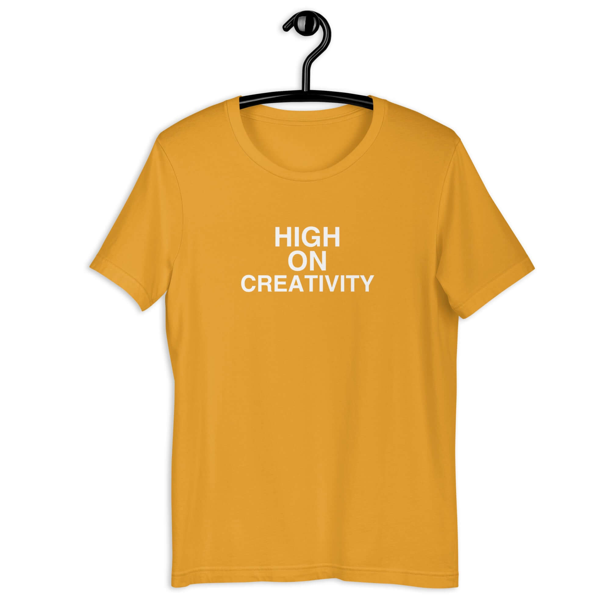 Mustard t-shirt on a hanger with the phrase “HIGH ON CREATIVITY” printed in white, centered on the chest.