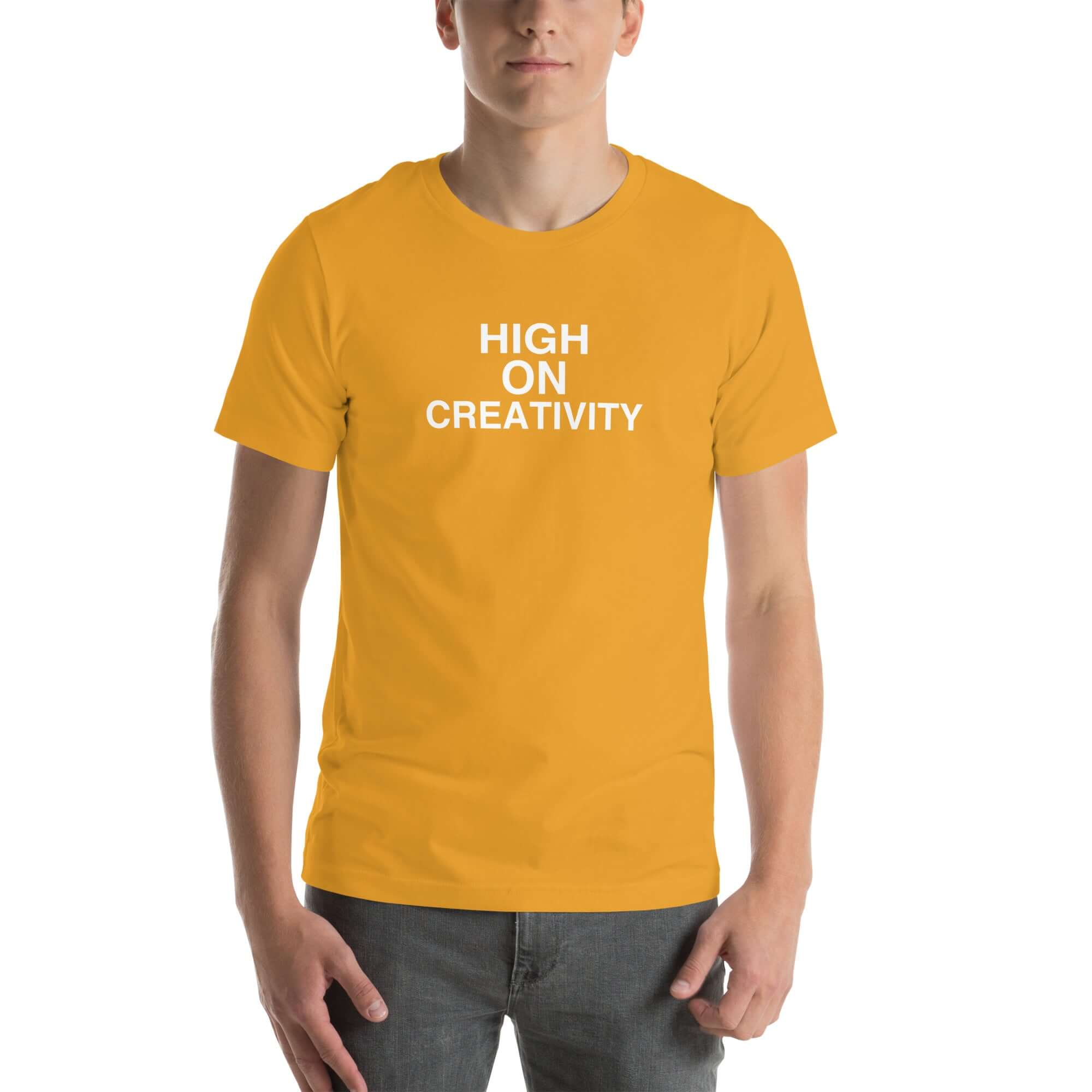 Man wearing a mustard t-shirt with the text ‘HIGH ON CREATIVITY’ in bold white capital letters, centered on the chest