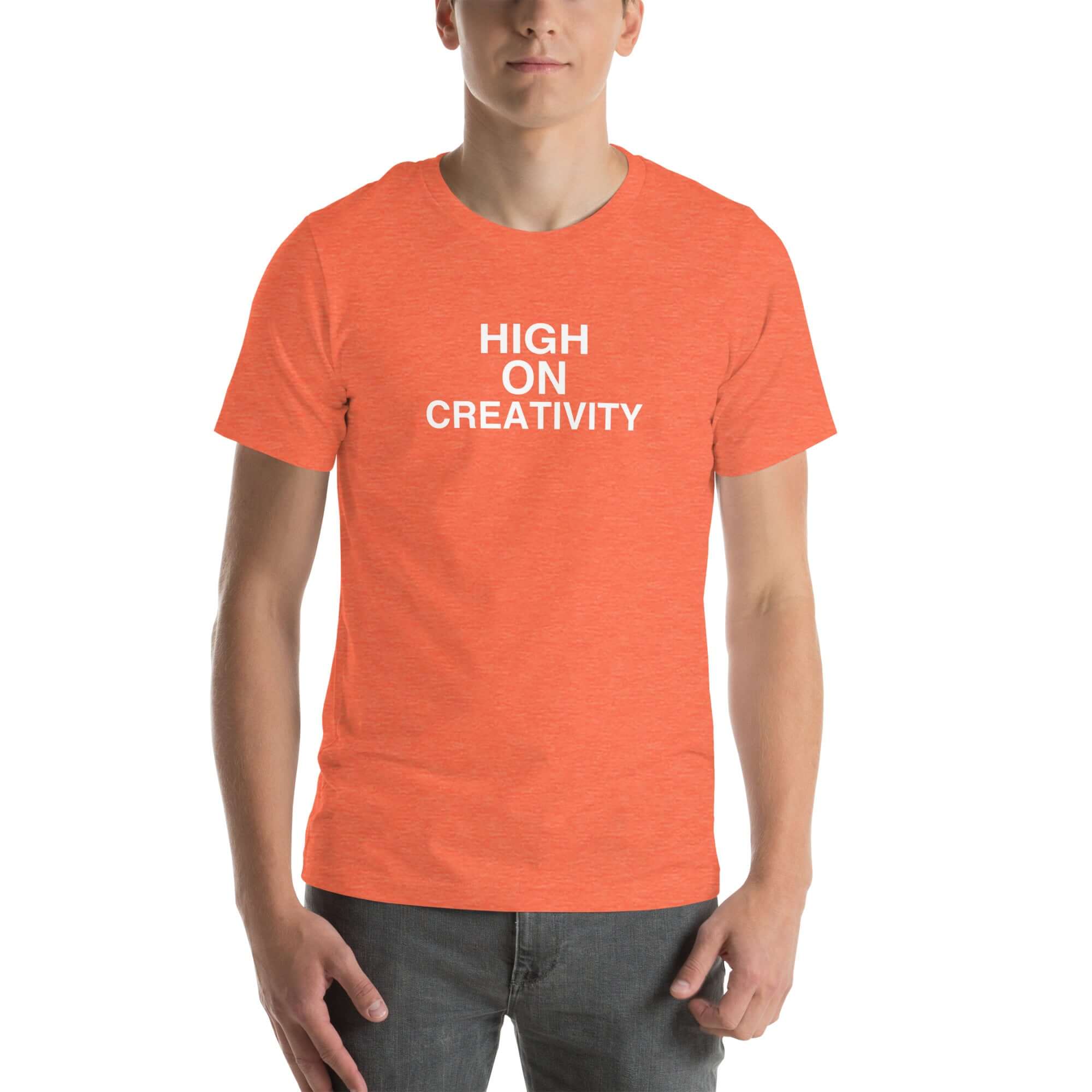 Man wearing a orange t-shirt with the text ‘HIGH ON CREATIVITY’ in bold white capital letters, centered on the chest