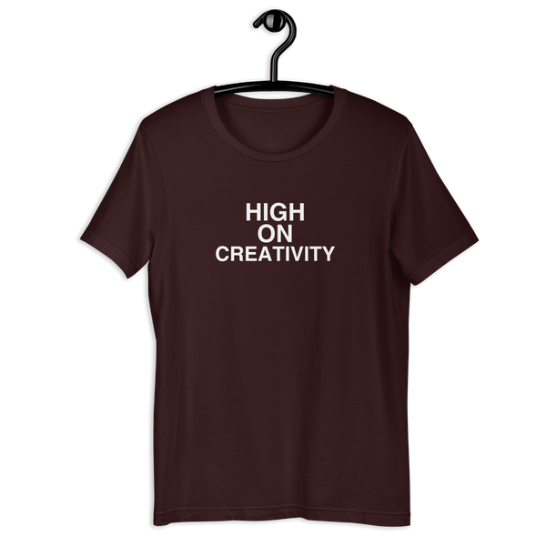 Oxblood black t-shirt on a hanger with the phrase “HIGH ON CREATIVITY” printed in white, centered on the chest.
