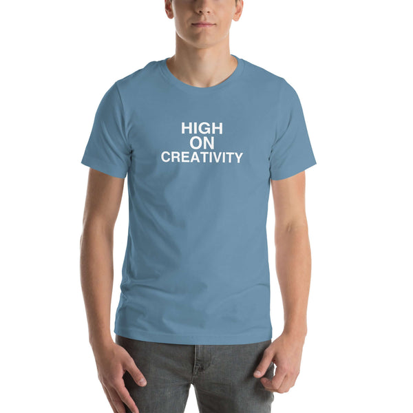 Man wearing a steel blue t-shirt with the text ‘HIGH ON CREATIVITY’ in bold white capital letters, centered on the chest