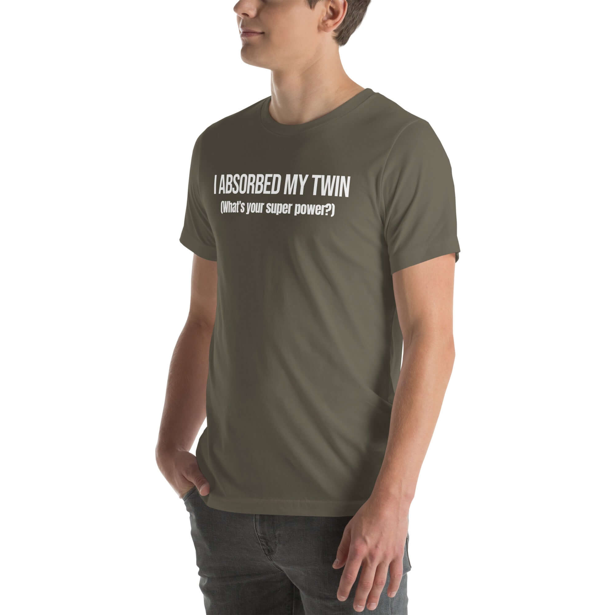 Man wearing army “I ABSORBED MY TWIN (What’s your super power?)” t-shirt, standing sideways with hands in pockets.