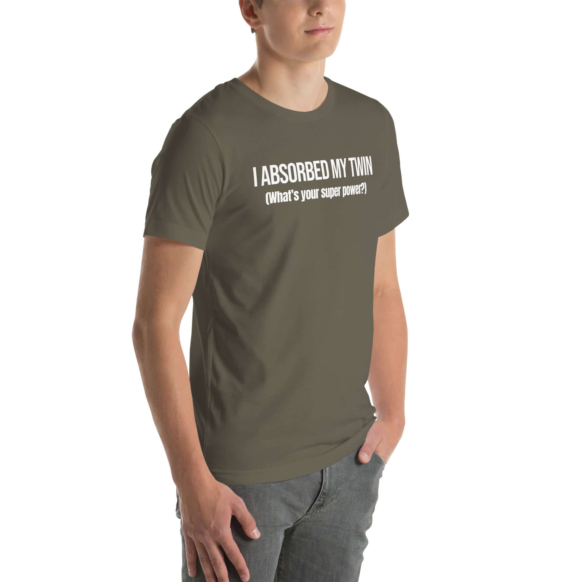 Man wearing army“I ABSORBED MY TWIN (What’s your super power?)” t-shirt, standing angled to the side with hands in pockets.