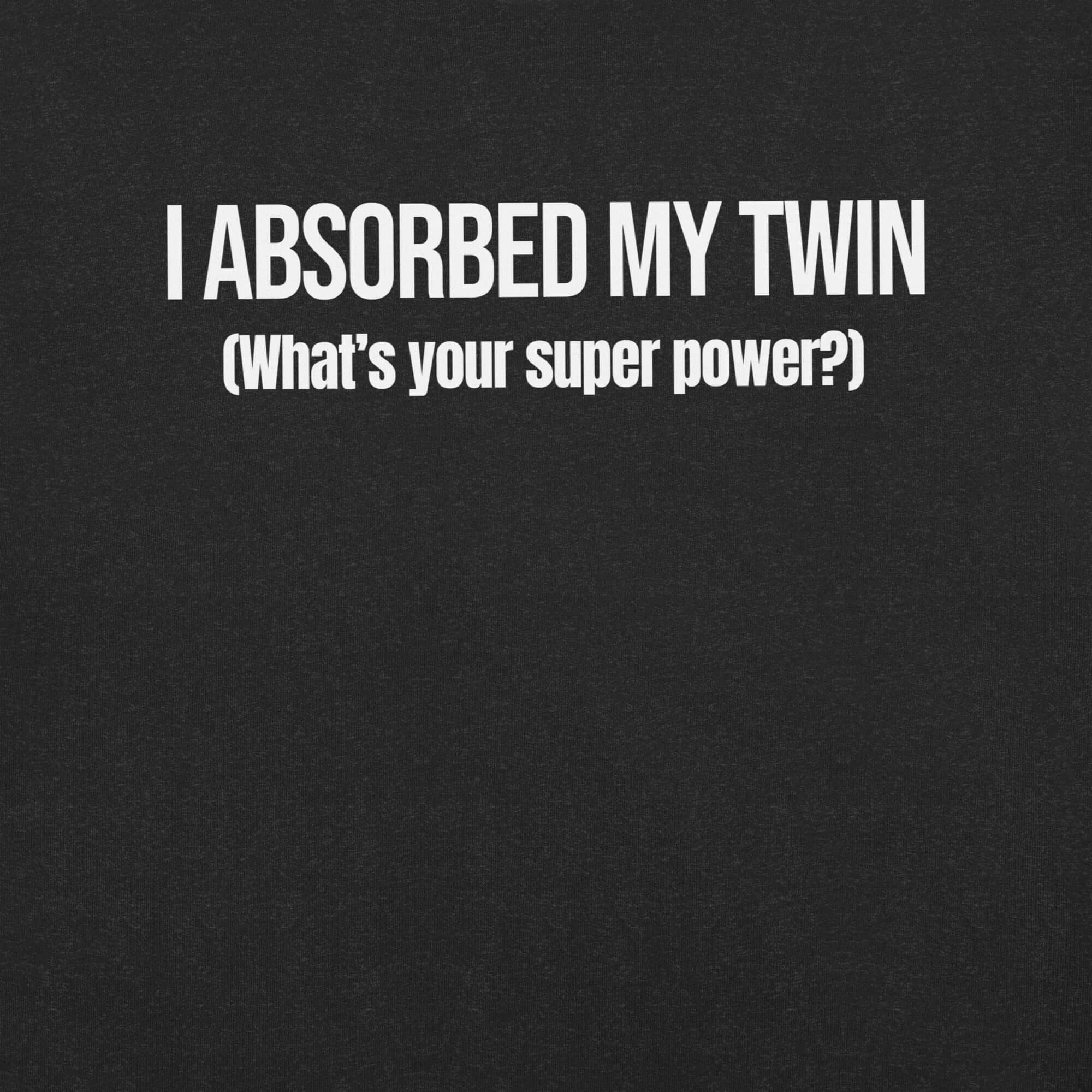 Close-up of black t-shirt with white text “I ABSORBED MY TWIN (What’s your super power?)” printed on the front.
