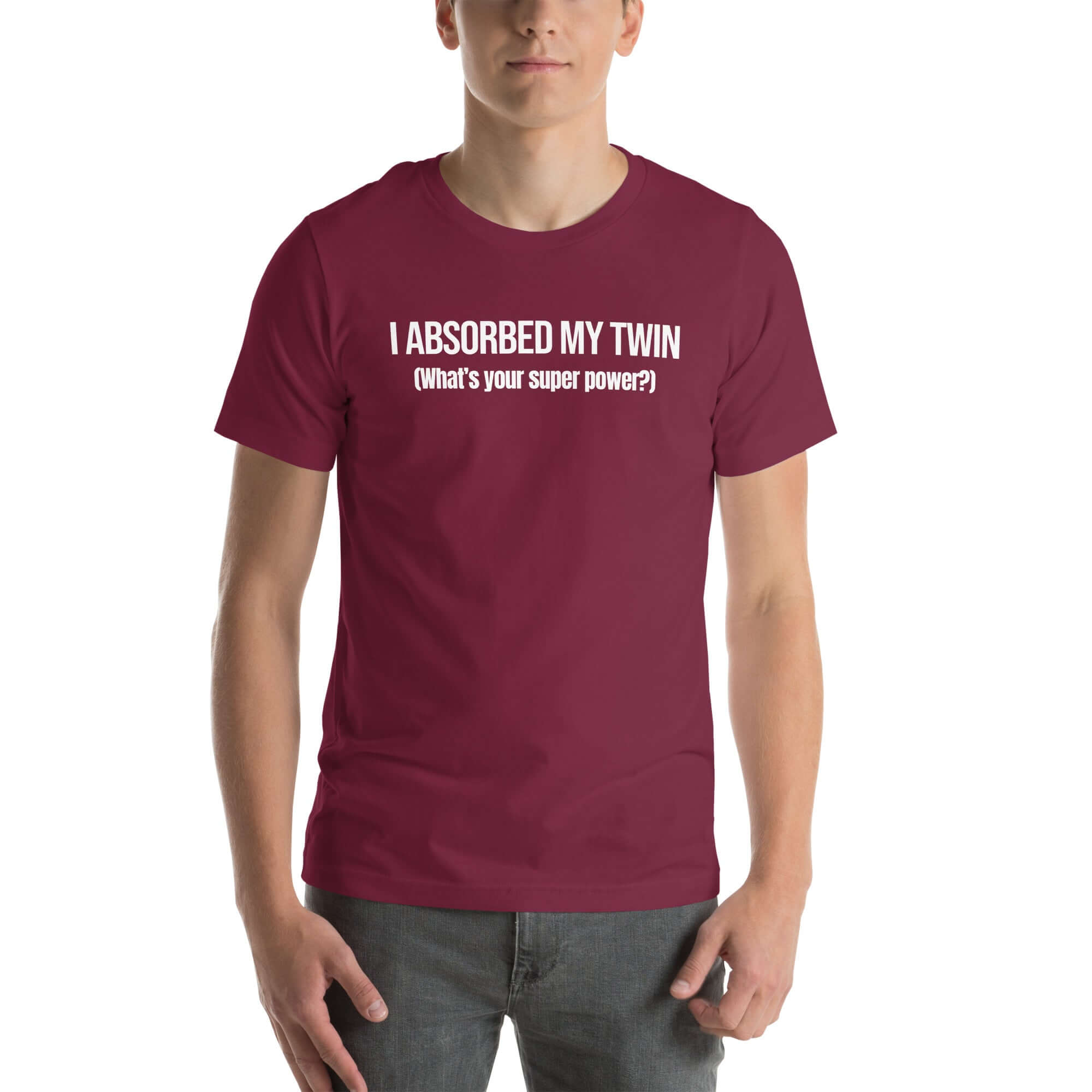 Man wearing maroon “I ABSORBED MY TWIN (What’s your super power?)” t-shirt, standing facing forward with hands relaxed.         