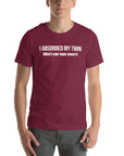 Man wearing maroon “I ABSORBED MY TWIN (What’s your super power?)” t-shirt, standing facing forward with hands relaxed.         
