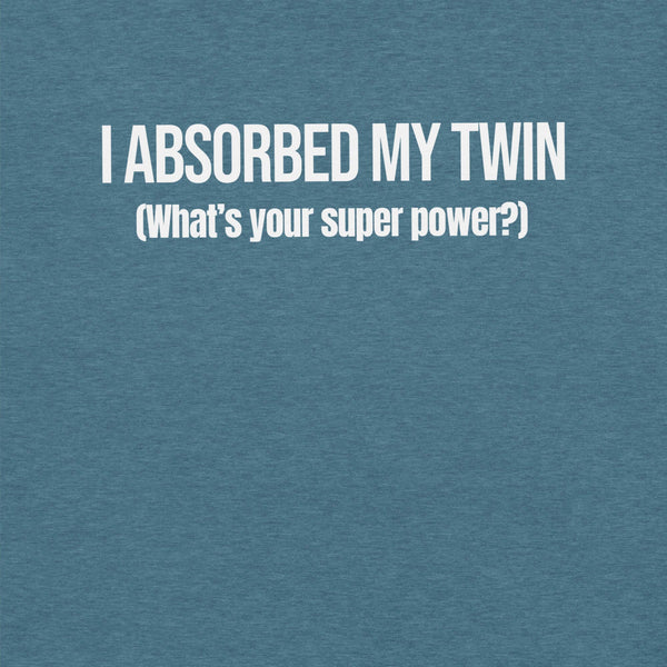 Close-up of teal t-shirt with white text “I ABSORBED MY TWIN (What’s your super power?)” printed on the front.