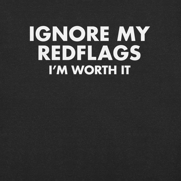 Close-up of black t-shirt with bold white text “IGNORE MY RED FLAGS I’M WORTH IT” printed on the front.        