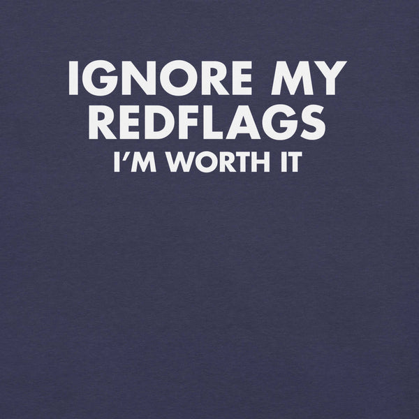 Close-up of navy t-shirt with bold white text “IGNORE MY RED FLAGS I’M WORTH IT” printed on the front.        