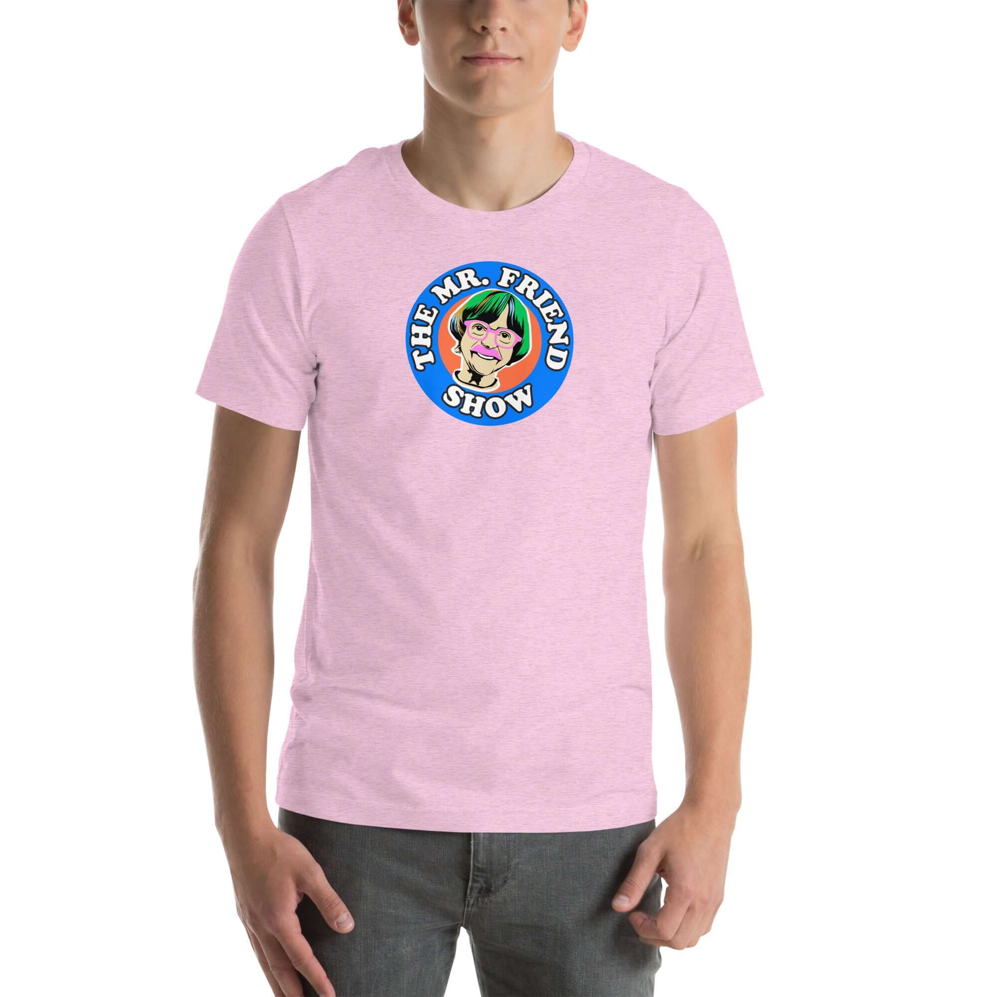 Man wearing a pink t-shirt featuring 'The Mr. Friend Show' logo with a colorful illustrated portrait and retro-style typography