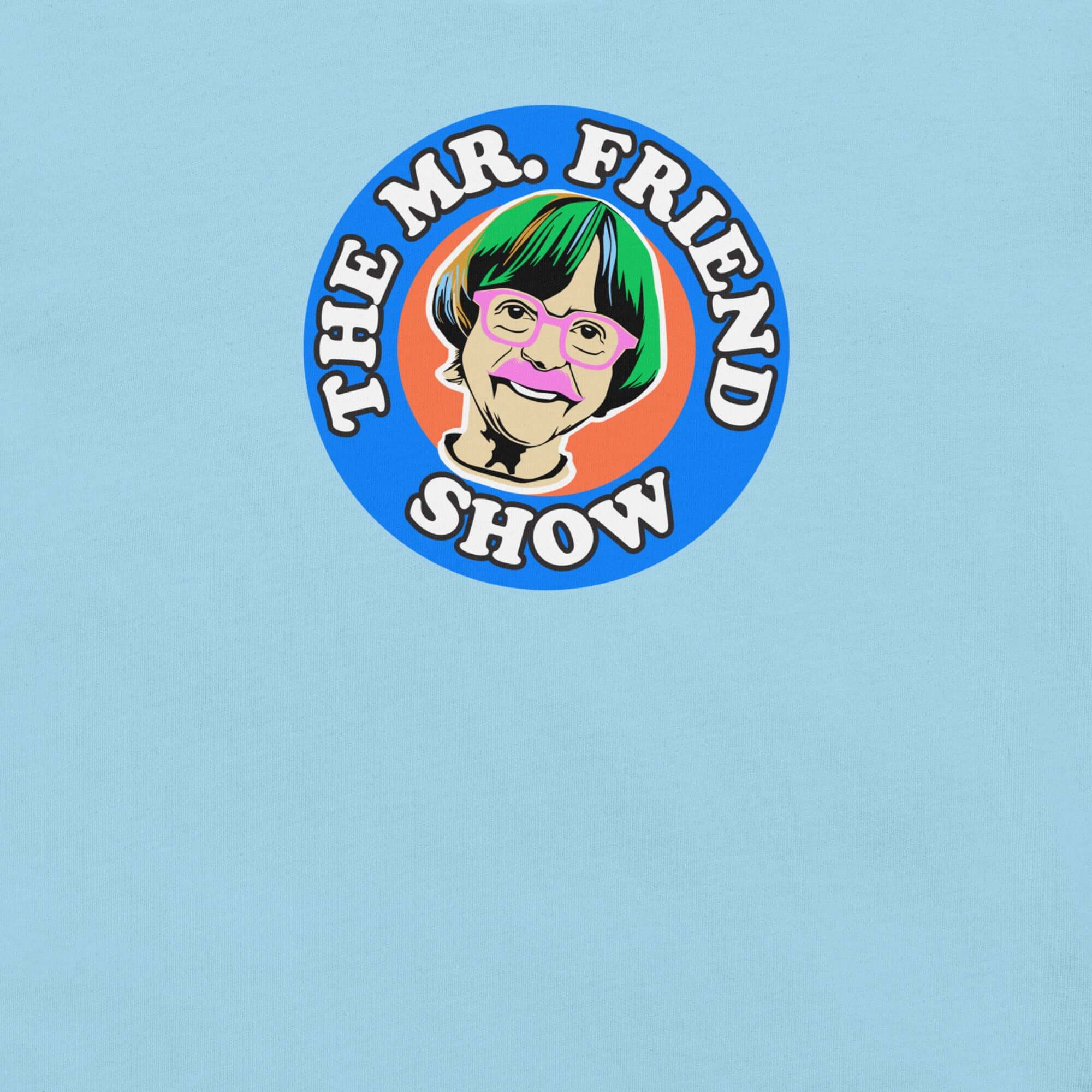 Man wearing a light blue t-shirt featuring 'The Mr. Friend Show' logo with a colorful illustrated portrait and retro-style typography