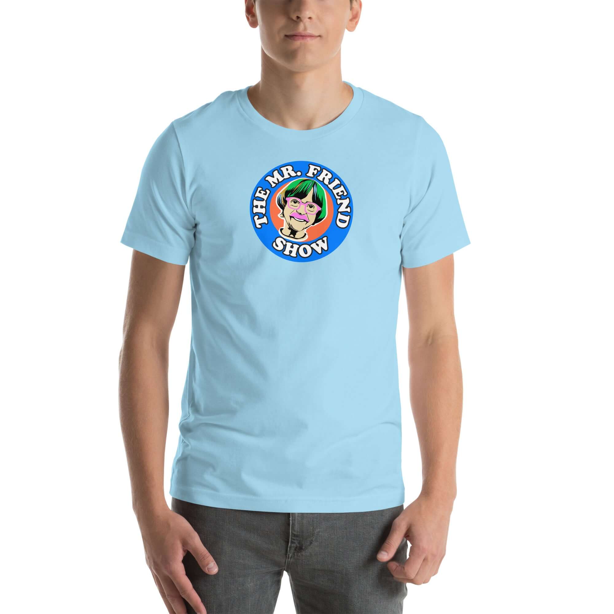 Man wearing a light blue t-shirt featuring 'The Mr. Friend Show' logo with a colorful illustrated portrait and retro-style typography