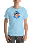 Man wearing a light blue t-shirt featuring 'The Mr. Friend Show' logo with a colorful illustrated portrait and retro-style typography