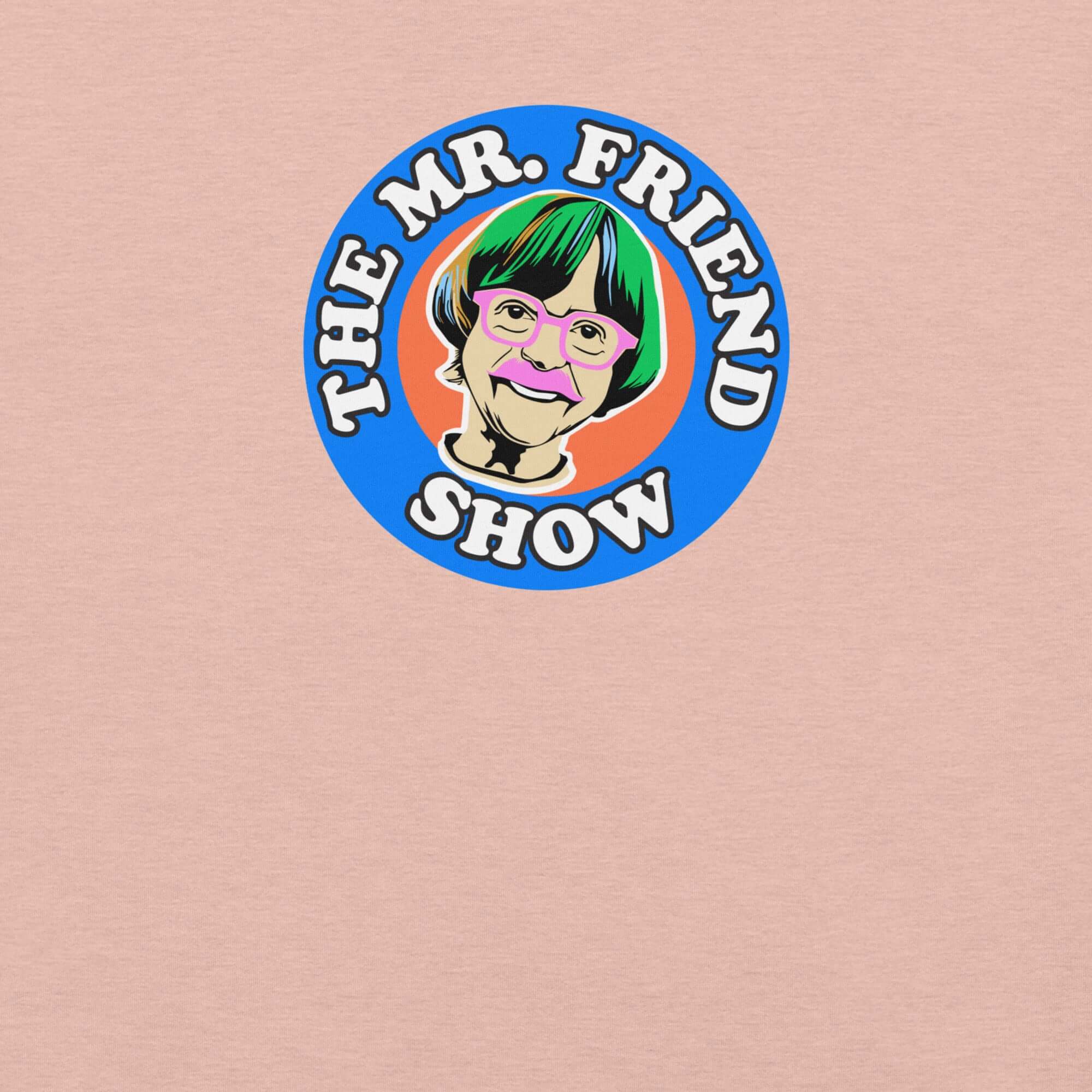 The Mr. Friend Show logo featuring a colorful illustrated portrait of an elderly person with green hair, pink glasses, and a pink mustache, on a peachy t-shirt background.