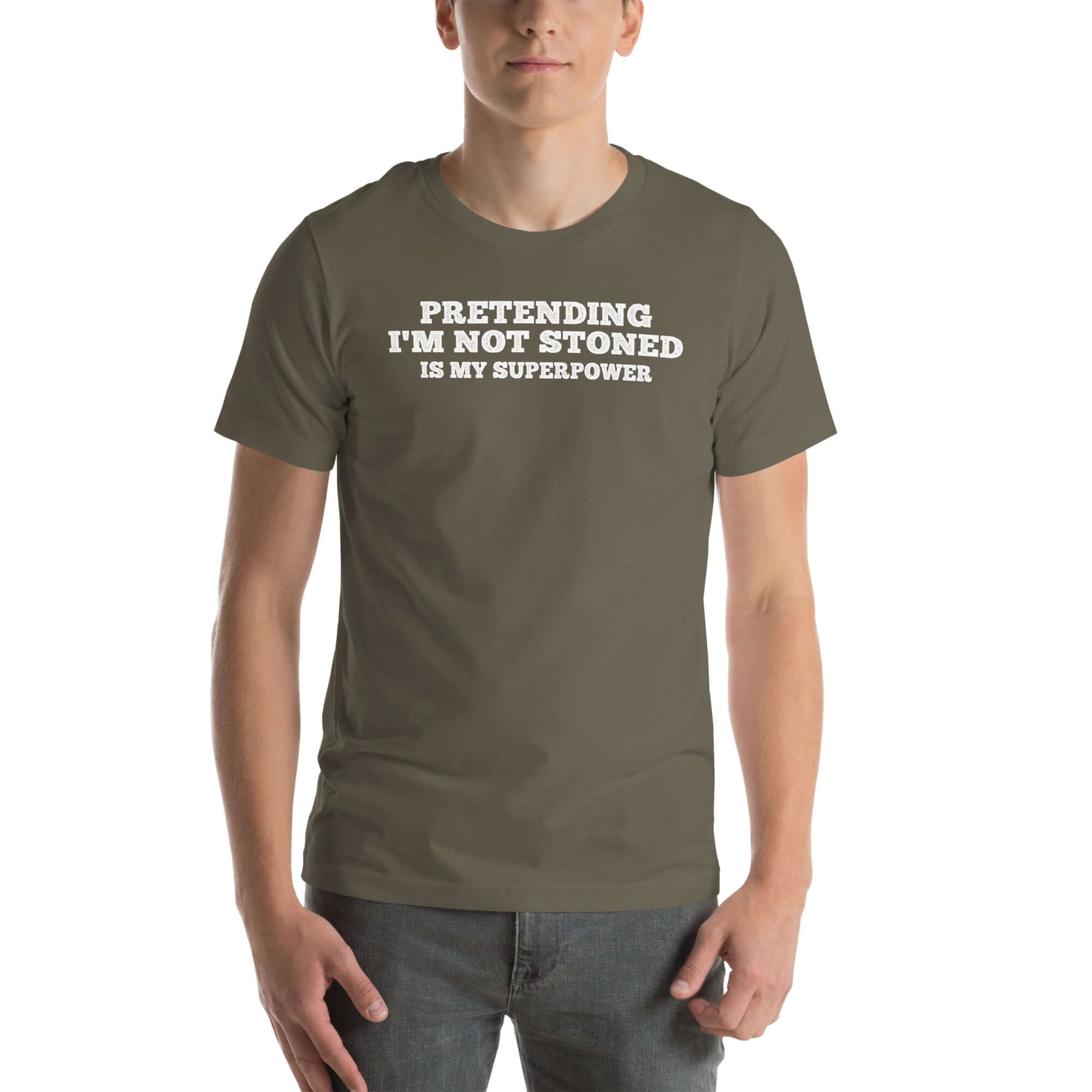 Man wearing army “PRETENDING I’M NOT STONED IS MY SUPERPOWER” t-shirt, standing casually with hands by pockets.