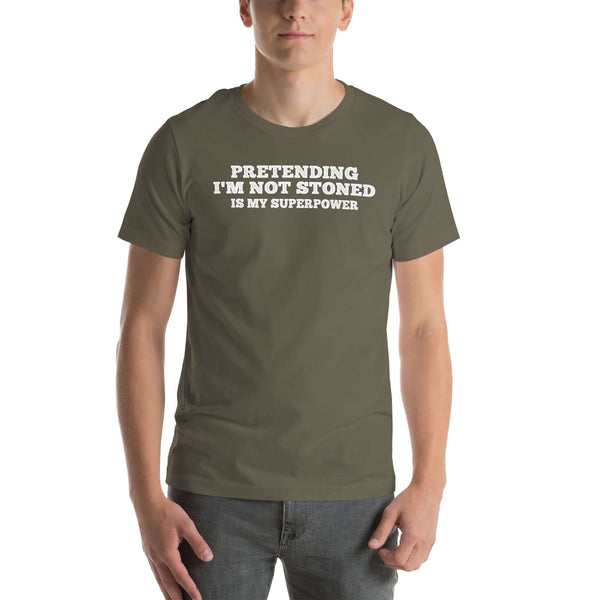 Man wearing army “PRETENDING I’M NOT STONED IS MY SUPERPOWER” t-shirt, standing casually with hands by pockets.