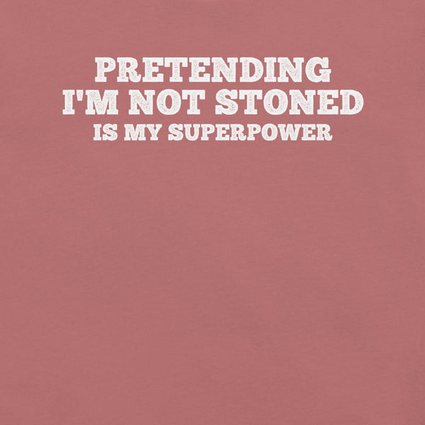 Close-up of mauve t-shirt with white text that says “PRETENDING I’M NOT STONED IS MY SUPERPOWER.”