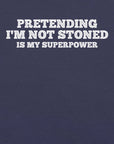 Close-up of navy t-shirt with white text that says “PRETENDING I’M NOT STONED IS MY SUPERPOWER.”