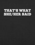 Close-up of black t-shirt with bold white text “THAT’S WHAT SHE/HER SAID” across the chest