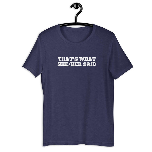 Navy “THAT’S WHAT SHE/HER SAID” t-shirt hanging on a hanger, front design visible.      