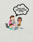 Ash t-shirt hanging on a hanger with cartoon kids and a speech bubble saying “TOLD YOU THE DARK WEB IS FUN.”