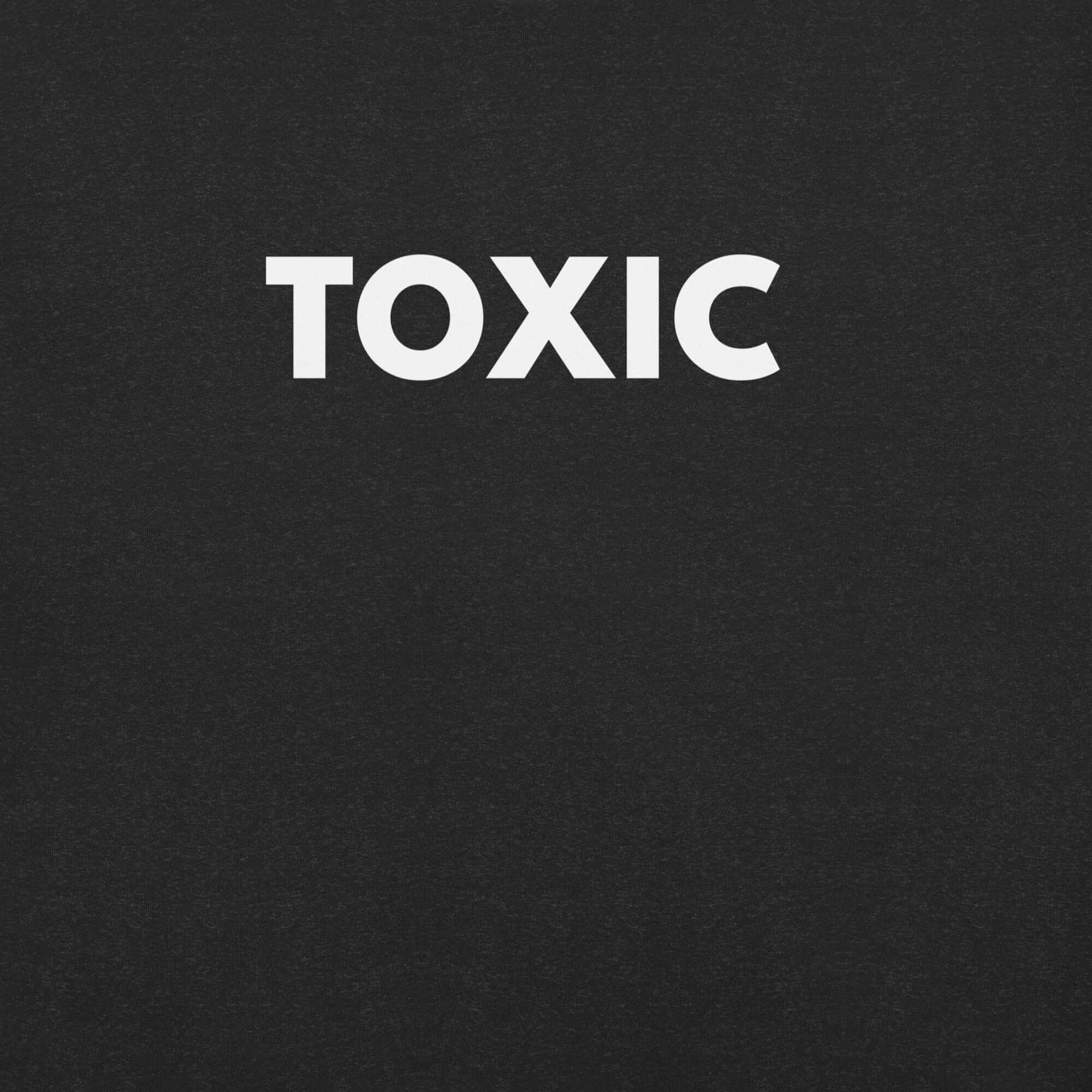 Close-up of black t-shirt with bold white “TOXIC” text printed on the front.