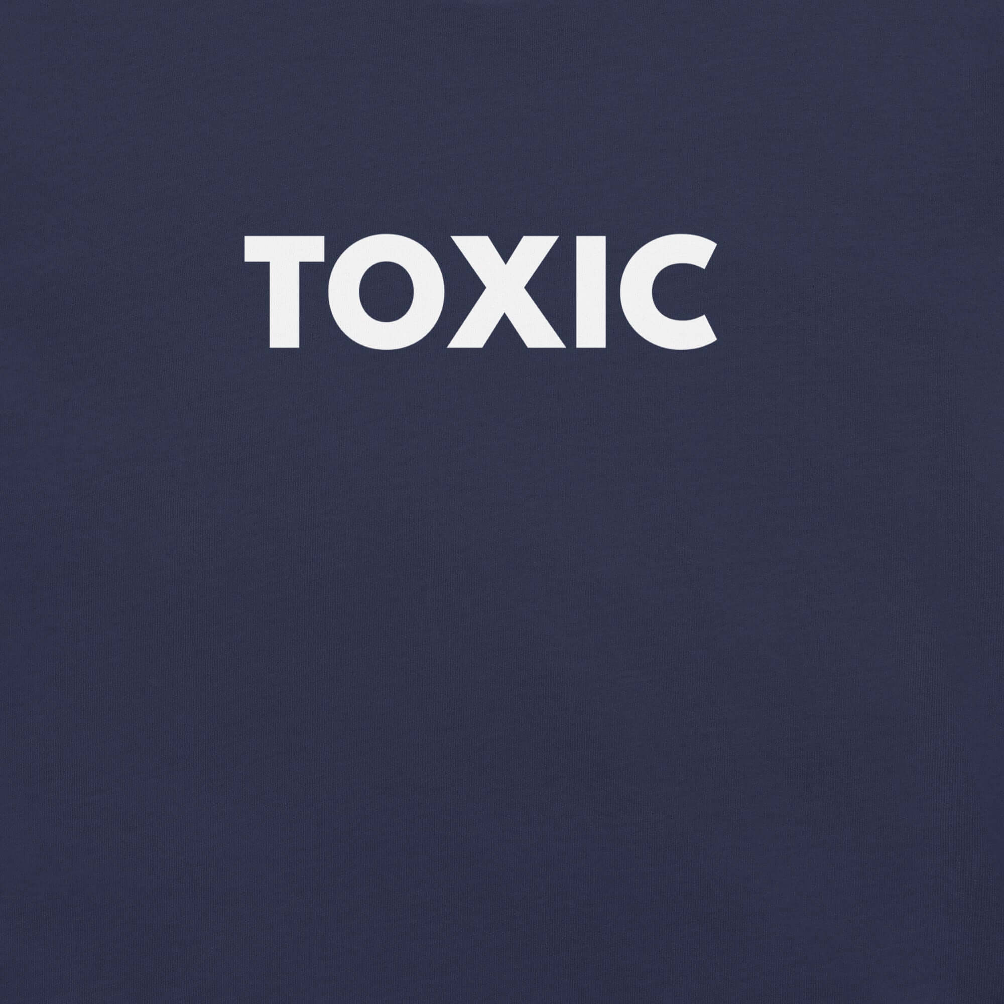 Close-up of navy t-shirt with bold white “TOXIC” text printed on the front.