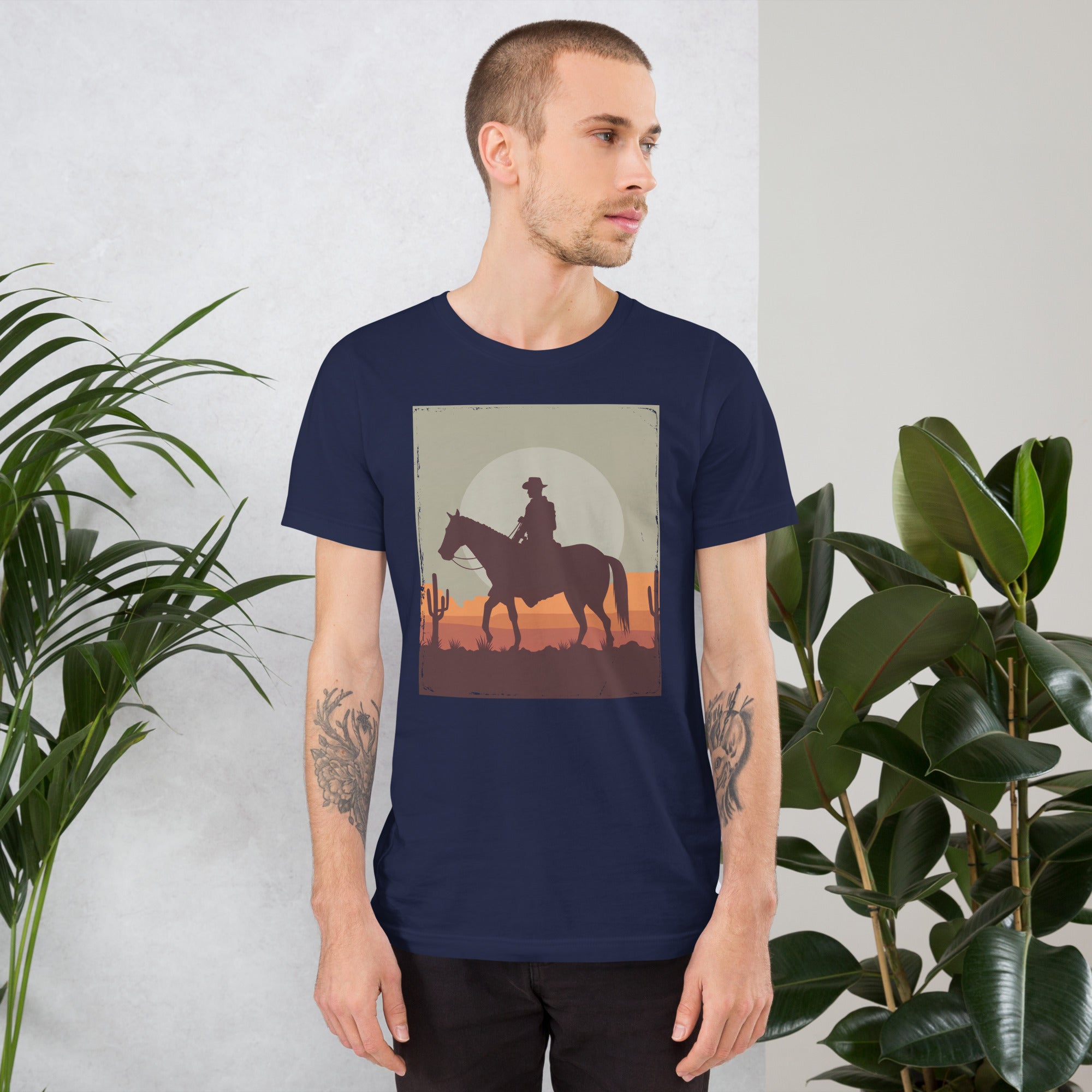 Unisex navy t-shirt featuring a cowboy silhouette against a sunset, surrounded by cacti, ideal for casual wear.