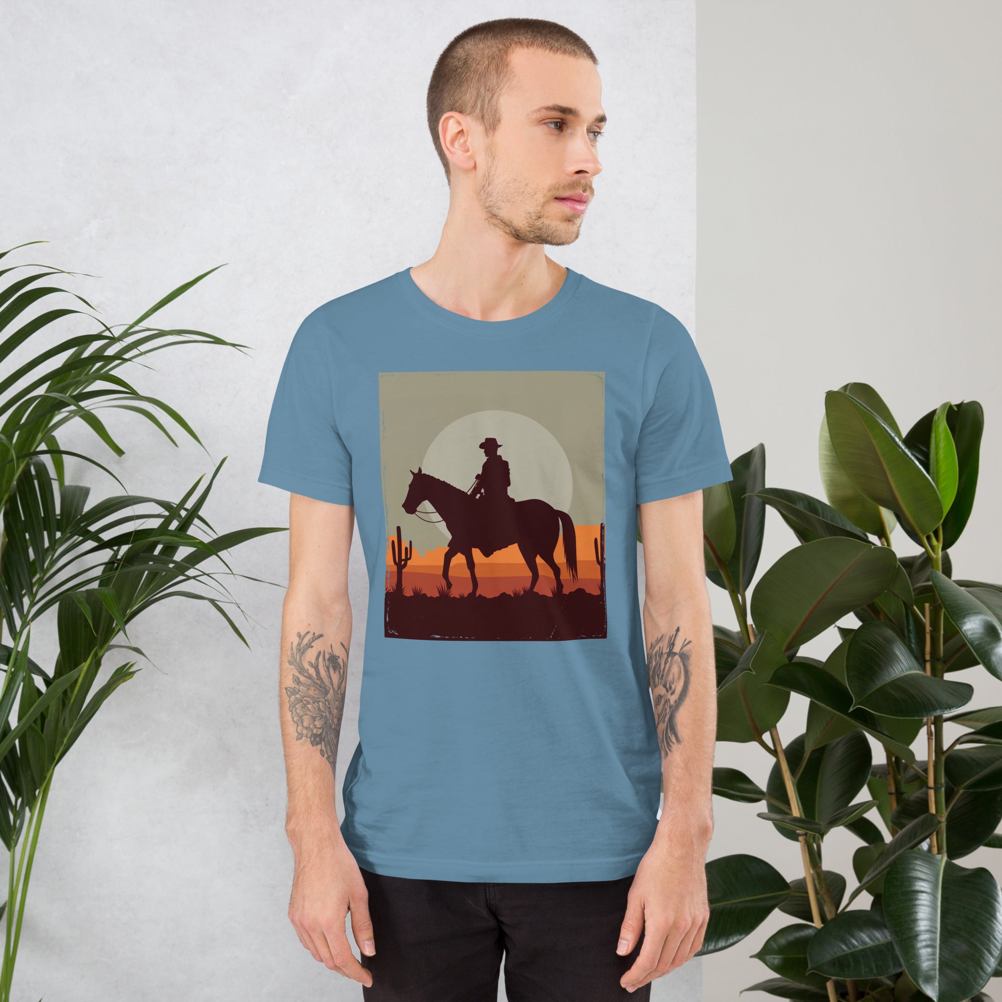 Unisex t-shirt featuring a cowboy silhouette against a sunset, perfect for casual, stylish wear in any season.