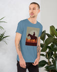 Unisex t-shirt featuring a silhouetted cowboy riding a horse against a sunset backdrop, perfect for casual wear.